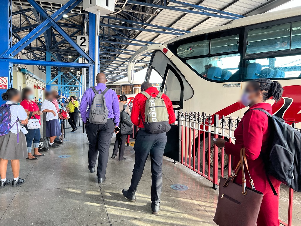 PTSC commuters boarding their bus at the depot